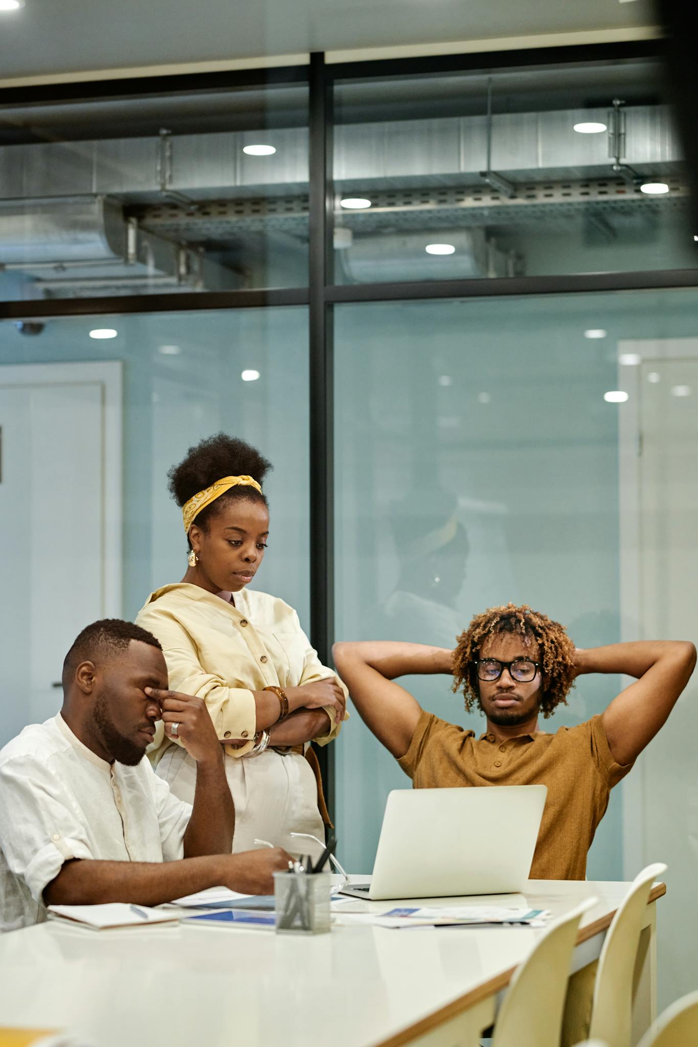 Group of young professionals discussing ideas in a modern office space.